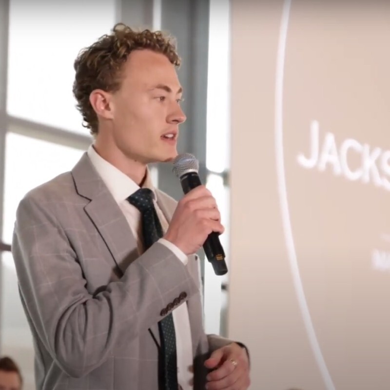 Jackson Rhoades speaking at a professional event